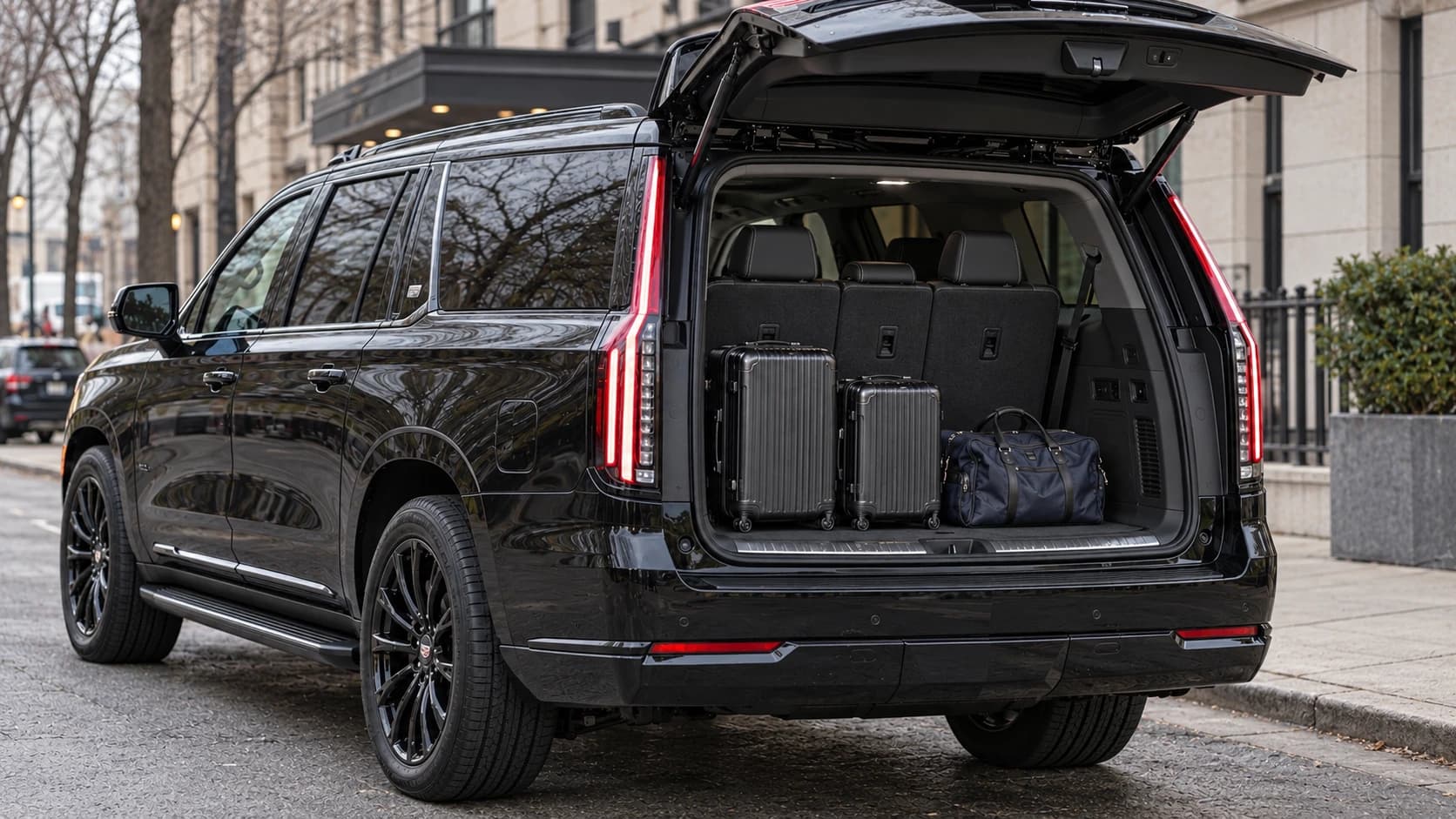 Luggage in the rear compartment of a black Cadillac Escalade