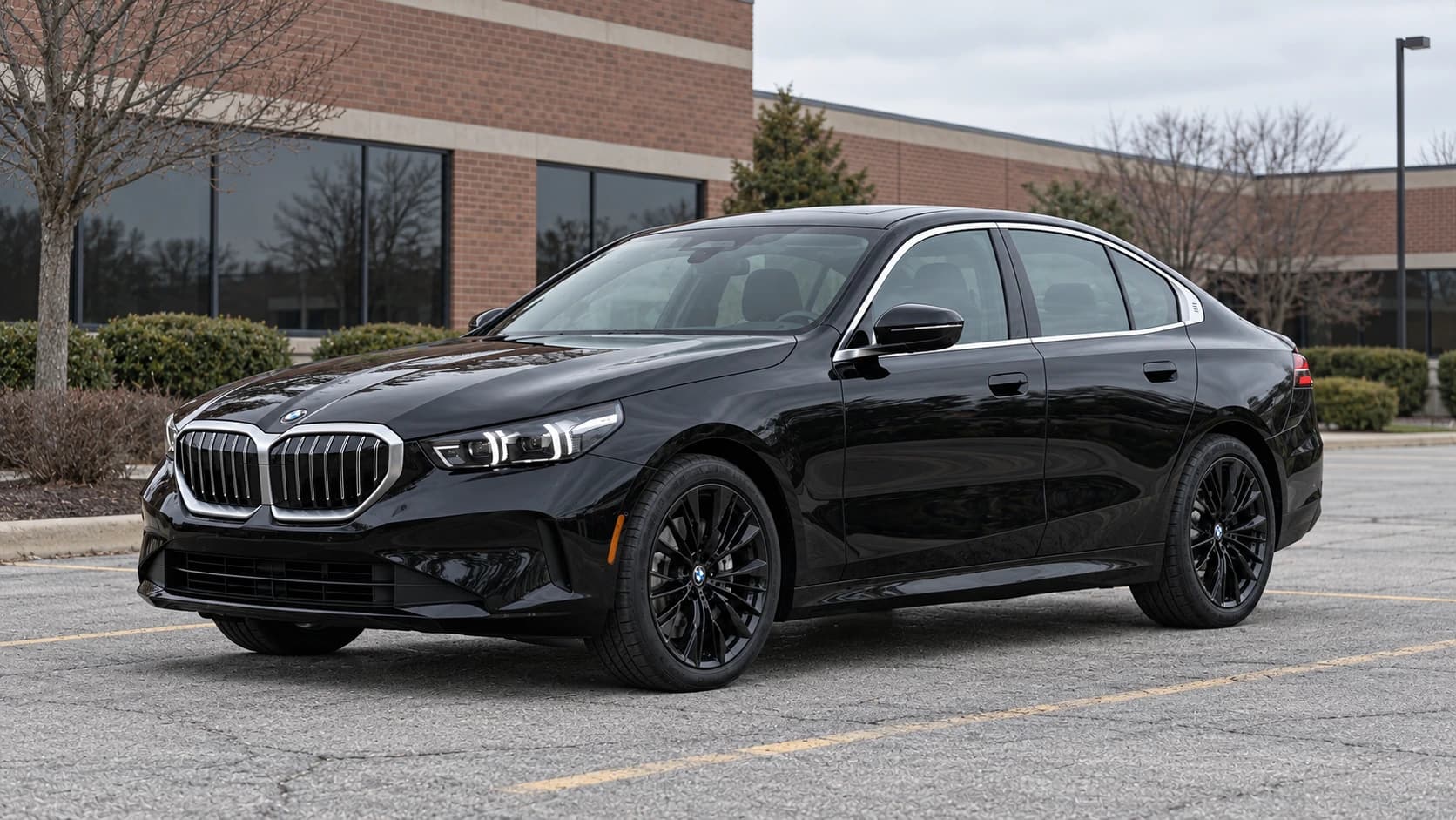 Black 2025 BMW 5 Series with black rims